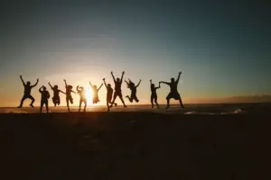 Young woman jumping on a beach at sunset
