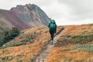 Backpacker walking along a mountain trail